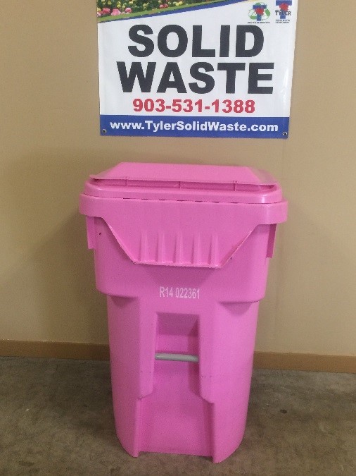 A large pink garbage container